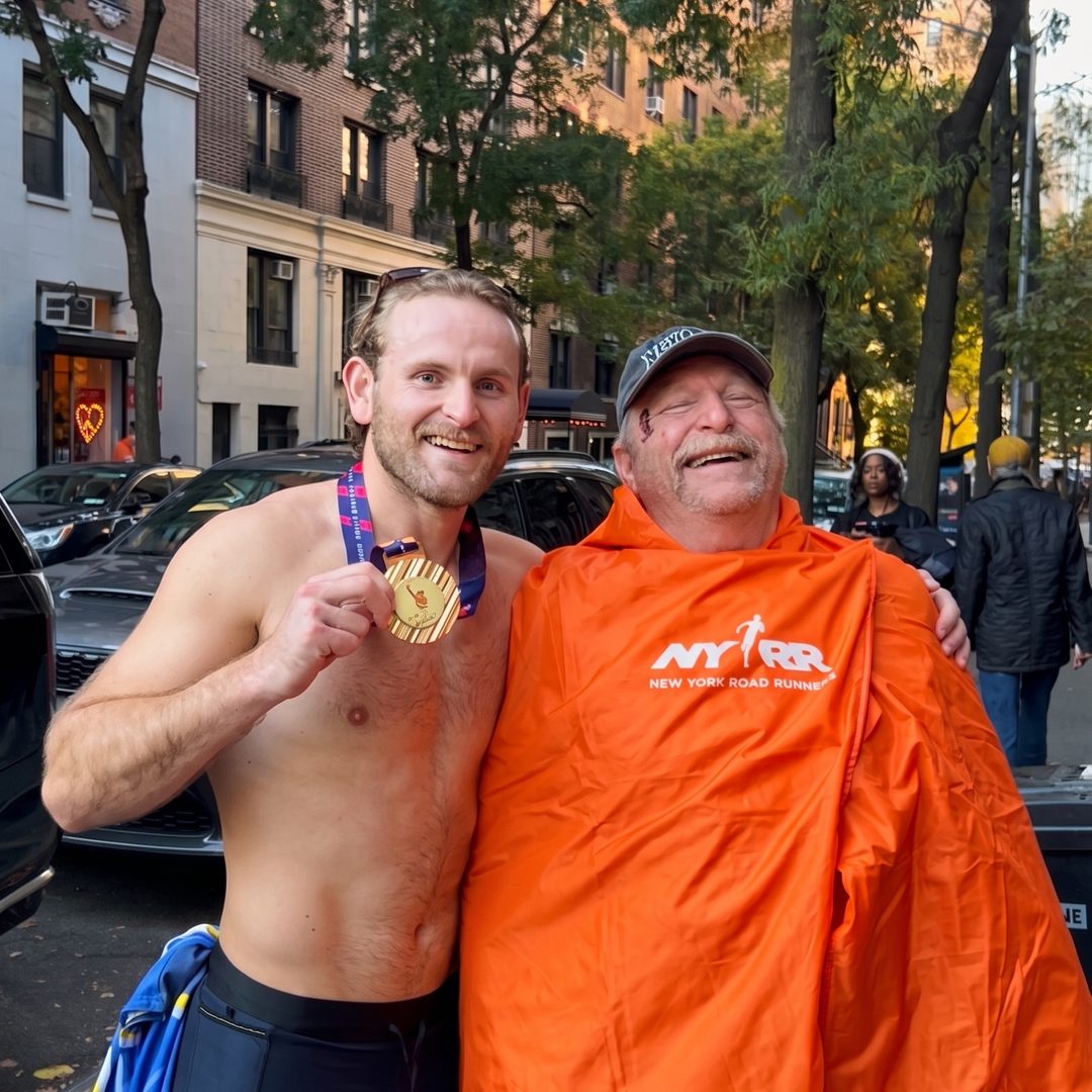 Vince and his father after the 2025 New York City Marathon, both laughing.
