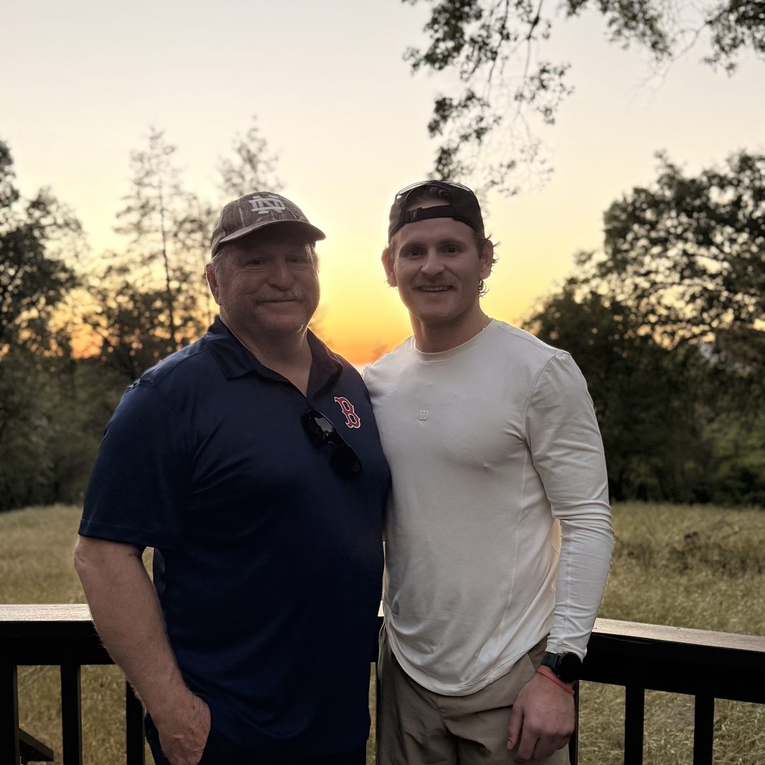 Vince and his father on a deck.