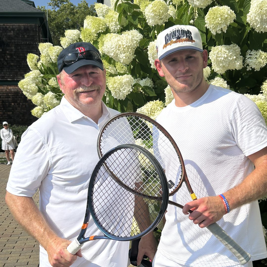 Vince and his father with tennis rackets.